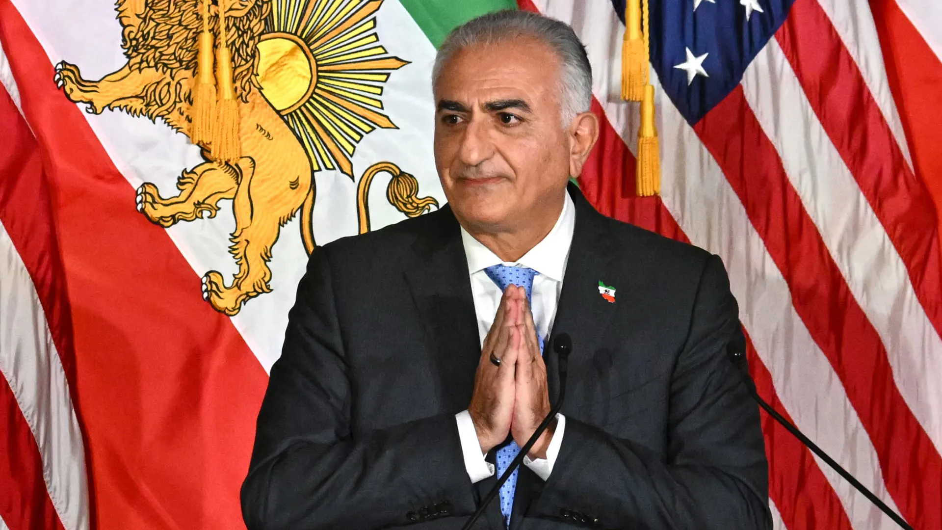 رضا بهلوي وخلفه العلم الامريكيي.